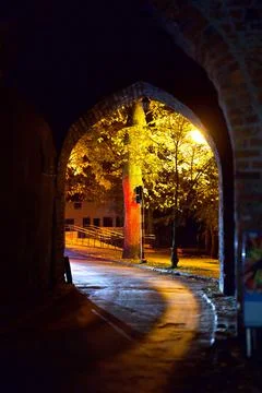 Night view through the arch of the medieval city walls Stock Photos