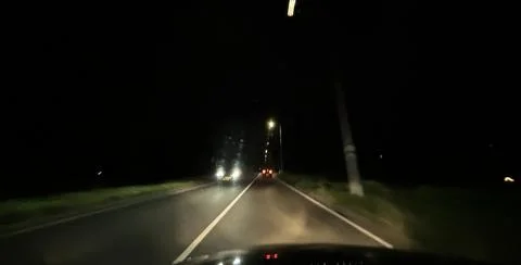 Night view through car windshield of illuminated Zuidas highway in Amsterdam Stock Photos
