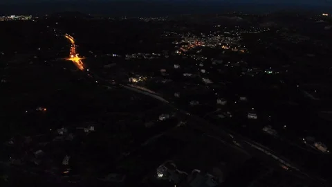 Night view of town against cloudy sky Stock Footage 114122913