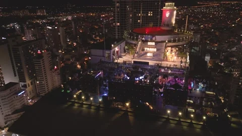 Night view of a vibrant rooftop venue  bustling city skyline colorful lights Stock Footage 297928671