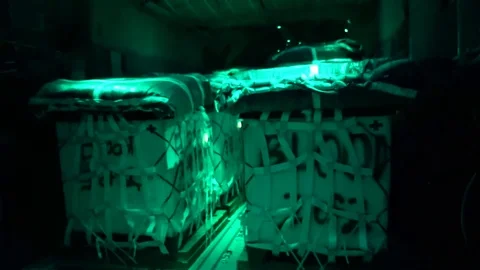 Night vision of cargo being loaded onto an aircraft at night Stock Footage 114019319