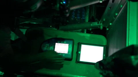 Night vision imagery of airman using touchscreen computer during airdrop Stock-Footage 98342556