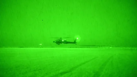 Night vision imagery of Apache helicopter flying low to ground Video stock 90645285