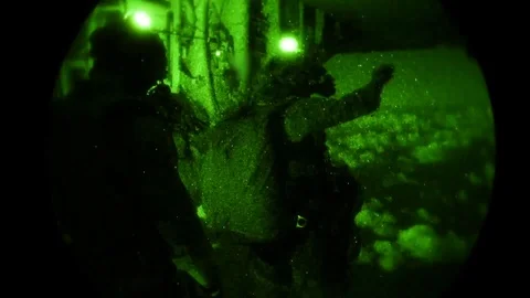 Night vision imagery of Special Operations airmen free-falling from Hercules Stockbeeldmateriaal 120121348