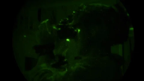 Night vision imagery of special ops parachutist checking night vision goggles Stock Footage 120121046