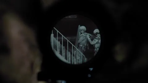 Night vision sniper scope, sniper sits in ambush on the rooftop Stock Footage 327460323