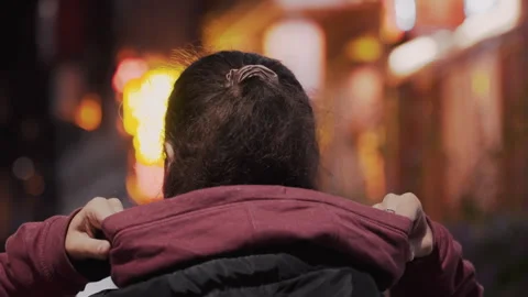 Night walking back view adjusting hood profile, glass framed face turns to neon Vídeo Stock 342281550