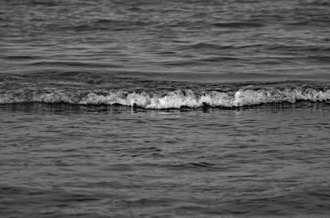 Night water ripple reflections. Black and White background. Dark tone. Stock Photos