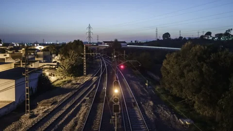 Nightfall Over Rail Track And Light Up Of A Town - Time Lapse Vídeo Stock 146259725