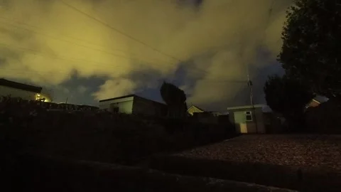 Nightfall time lapse transition into starry cloudy night sky from home garden Stock Footage 325743118