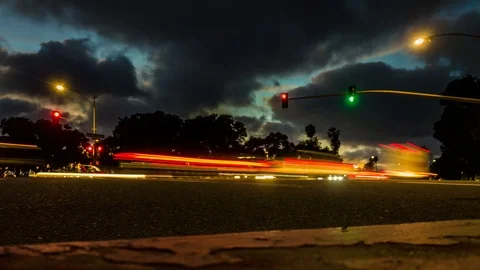 Nightlapse of evening traffic intersection from curb Stock Footage 100958482
