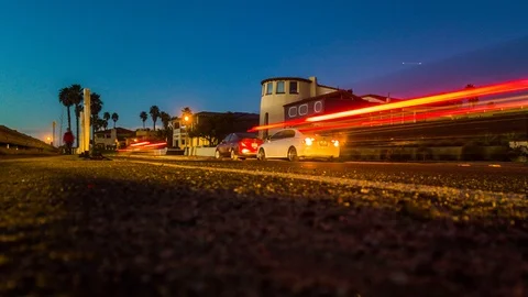 Nightlapse of evening traffic from pavement with pan UP Stock Footage 101211656