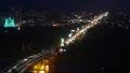 Nightlife city timelapse, cars moving across river bridge lights HD Footage