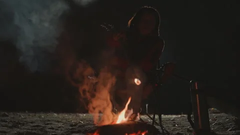 Nightly camping with warm fire. Serene moment of solitude beside flickering Stock Footage 335068970