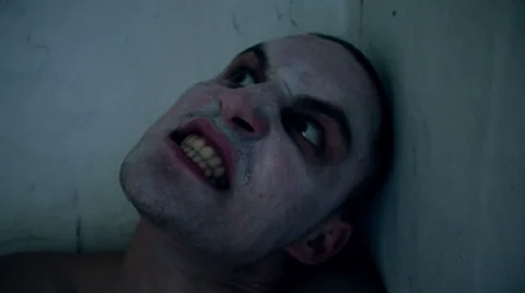 Nightmare guy looking at the camera and bites Stock Footage 67599410