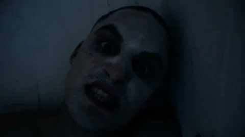 Nightmare guy looking at the camera and bites Stock Footage 67599444