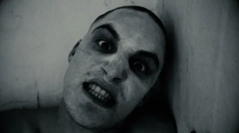 Nightmare guy looking at the camera and bites, black and white Stock Footage 67599565