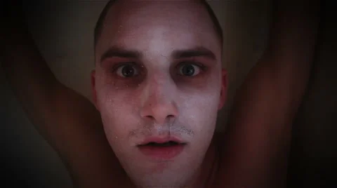 Nightmare  psycho guy looking at the camera and bites Stock Footage 48386437