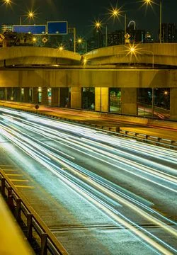 A nightscape view with bright glowing light trails effect of many cars head.. Stock Photos