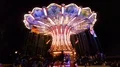 Nightshot colorful chain carousel in action with happy people 4k or 4k+ Resolution