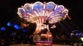 Nightshot colorful chain carousel in action with happy people 4k or 4k+ Resolution