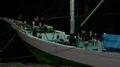 Nightshot person living on boat in a domestic indonesian harbor HD Footage