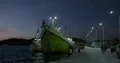 Nightshot simple wooden freight ship in a domestic indonesian harbor 4k or 4k+ Resolution