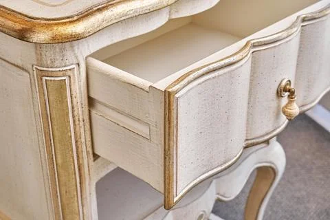 Nightstand in classical style with open drawer in room Stock Photos