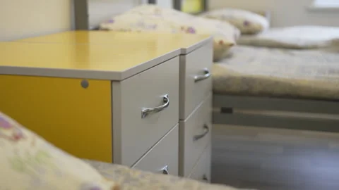 Nightstands with drawers between beds in camp bedroom Stock Footage 314654633