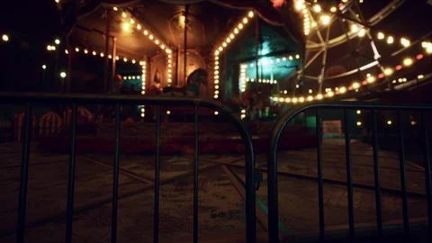Nighttime abandoned carousel with glowing lights in empty park Ilustração Stock