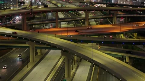 Nighttime aerial drone footage of a multi-level freeway interchange in Stock Footage 279215983