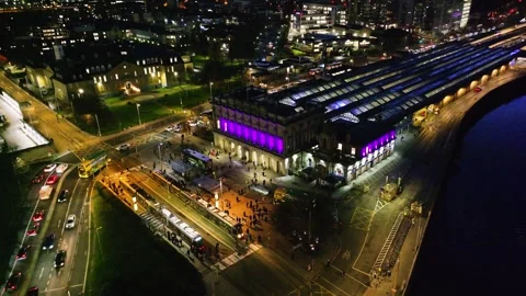 Nighttime Aerial of Dublin Train Station with Vibrant Purple Lights Stock Footage 332444638