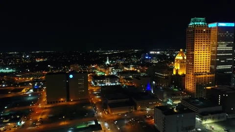 Nighttime aerial flight over downtown Tulsa Oklahoma capturing city lights Stock Footage 344722320