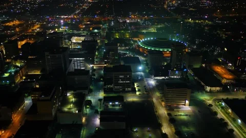 Nighttime aerial flight over downtown Wichita Kansas capturing city lights Stock Footage 344728245
