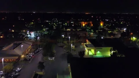 Nighttime aerial flight over downtown Bakersfield California and city lights Stock Footage 344738592