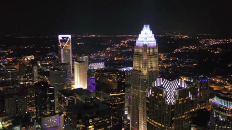 Nighttime aerial flight over downtown Charlotte North Carolina, city lights Stock Footage 344779316