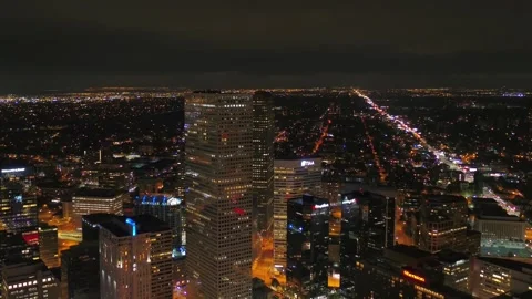 Nighttime aerial flight over downtown Denver Colorado capturing city lights Stock Footage 344783734