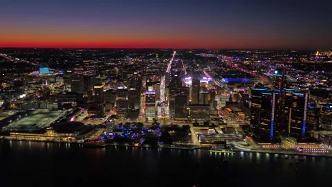 Nighttime aerial flight over downtown Detroit Michigan with bright city lights Stock Footage 344787326