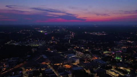 Nighttime aerial flight over Raleigh North Carolina capturing glowing streets Stock Footage 344641920