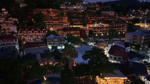 Nighttime aerial view of illuminated buildings and beach in tropical resort area Stockbeeldmateriaal 337418924