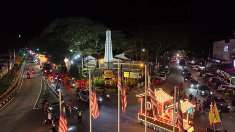Nighttime Air Itam deity procession with illuminated religious floats and flags Stock Footage 345445001