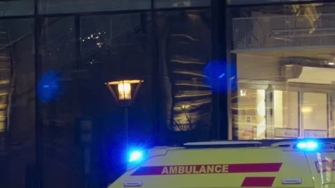 Nighttime ambulance reflection visuals. Reflections of ambulance siren glow Video stock 331397942