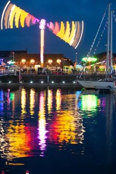 Nighttime Amusement Park Lights Reflected on Water Foto stock