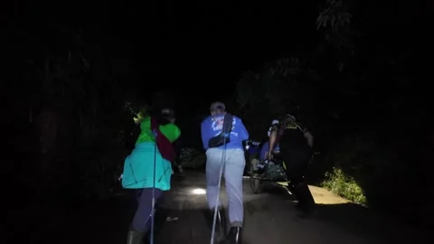 Nighttime Ascent With Porters Pull Wheeled Cart Stock Footage 345144623