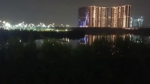 Nighttime atmosphere with views of high-rise buildings on the beach Stock Footage 264544729