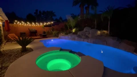 Nighttime backyard pool &amp; hot tub Stock Footage 192700525