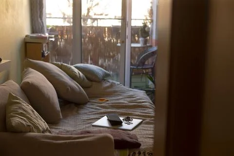 Nighttime balcony scene featuring cozy seating and gentle shadows Stock Photos