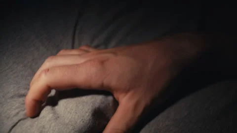 Nighttime Bedroom Scene with Fingers Digging into Gray Fabric Vidéo 345553576