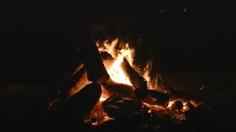 Nighttime campfire close-up burning low with no people present Stock Footage