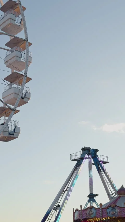 Nighttime carnival with swinging ship. Sunset amusement park swing with colorful Stock Footage 332735558